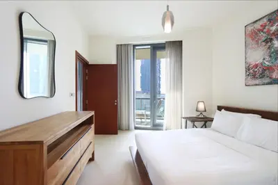 a bedroom with a bed and a mirror at Prime Located 2BR Near Burj Khalifa & Dubai Mall in Dubai