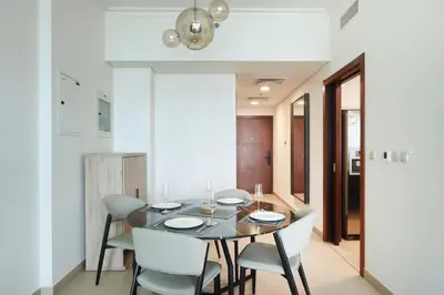 a dining room with a table and chairs at Prime Located 2BR Near Burj Khalifa & Dubai Mall in Dubai