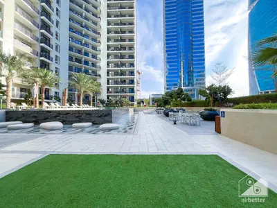 a courtyard in a city with tall buildings at Wonderful Stay at Zada Tower l 1BR with Balcony in Dubai