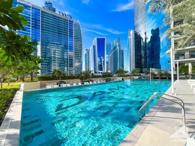 a swimming pool in a city with tall buildings at Wonderful Stay at Zada Tower l 1BR with Balcony in Dubai