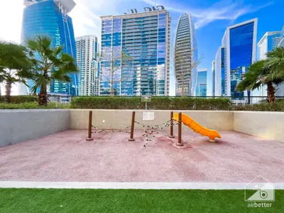 a playground in a city with tall buildings at Wonderful Stay at Zada Tower l 1BR with Balcony in Dubai