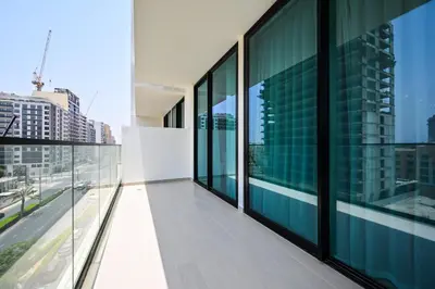 a balcony of a building with glass windows at Golden Stays - Binghatti Amber I Luxury 1BR Apartment I Fully Furnished I Pool & Gym in Dubai