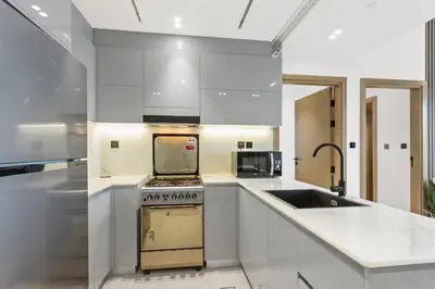 a kitchen with white counters and a stove top oven at Comfortable 2 Bedroom in Business Bay in Dubai