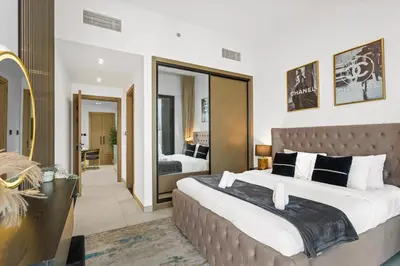 a bedroom with a large bed and a large mirror at Comfortable 2 Bedroom in Business Bay in Dubai