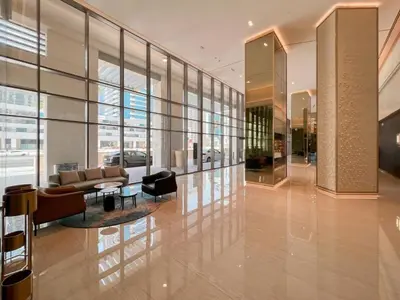 a lobby of a building with a couch and chairs at Vogue Downtown Bellevue Towers near Burj Khalifa and Dubai Mall, One Bedroom Apartment with City View, Full Access to all Amenities in Dubai