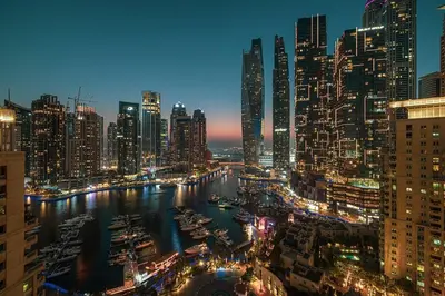 a view of a city at night with boats in the water at Lux 2BHK w Marina view w Sky Light Mesk 2007 in Dubai