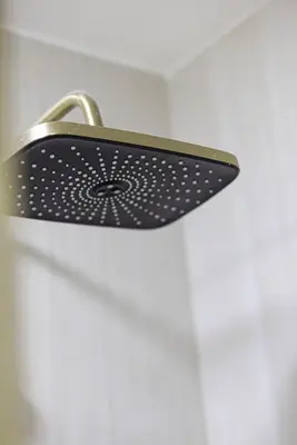 a shower head with a metal holder on a door at Lux 2BHK w Marina view w Sky Light Mesk 2007 in Dubai