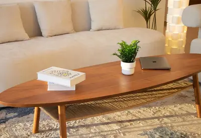 a coffee table in a living room with a laptop on it at Luxury 2 BHK in Jumeirah By dPie Emaar 2008 in Dubai