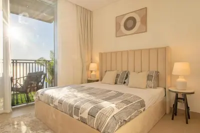 a bedroom with a large bed and a balcony at Luxury 2 BHK in Jumeirah By dPie Emaar 2008 in Dubai