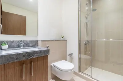 a bathroom with a toilet sink and a shower at Luxury 2 BHK in Jumeirah By dPie Emaar 2008 in Dubai