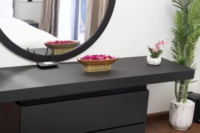 a black dressing table with two bowls on it and a mirror at Lux 4BHK in JBR 5 Mins Walk to Beach Sadaf 8 102 in Dubai