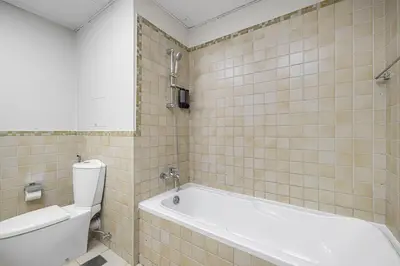 a bathroom with a white tub and a toilet at Lux 4BHK in JBR 5 Mins Walk to Beach Sadaf 8 102 in Dubai