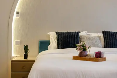 a bedroom with a white bed with flowers on it at Luxury Villa in Jebel Ali Village By dPie in Dubai