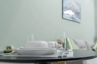 a table with plates and dishes on top of it at Dubai Marina - Perfect Studio Apartment in Dubai