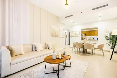 a living room with a couch and a table at FIRST CLASS 2BR Downtown Glam Burj View in Dubai