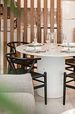 a white table with wine glasses on top of it at Modern 1BR Apartment Lamtara 3 in MJL in Dubai