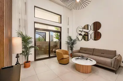 a living room with a couch and a table at Modern 1BR Apartment Lamtara 3 in MJL in Dubai