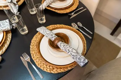 a table with plates and utensils on a table at Bright 2BR Sports City Near Miracle GardenParks in Dubai