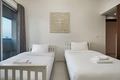 two beds sitting next to each other in a room at Bright 2BR Sports City Near Miracle GardenParks in Dubai