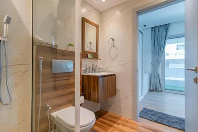 a bathroom with a toilet and a sink and a shower at Dubai Marina - 1BHK Modernistic Apartment in Dubai