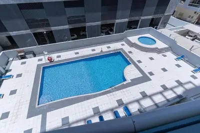 an overhead view of a swimming pool in a building at Dubai Marina - 1BHK Modernistic Apartment in Dubai