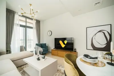 a living room with a couch and a table at Vogue Downtown Bellevue Towers near Burj Khalifa and Dubai Mall, One Bedroom Apartment with Balcony and City View, Full Access to all Amenities in Dubai