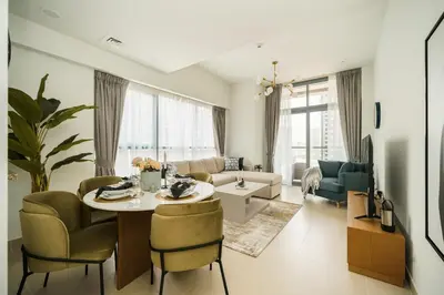 a living room with a table and chairs at Vogue Downtown Bellevue Towers near Burj Khalifa and Dubai Mall, One Bedroom Apartment with Balcony and City View, Full Access to all Amenities in Dubai