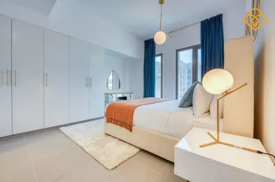 a bedroom with a bed and a large window at Keysplease Great Family 2 BR Apt, Townsquare in Dubai