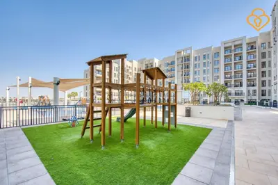 a park with a playground in front of a building at Keysplease Great Family 2 BR Apt, Townsquare in Dubai