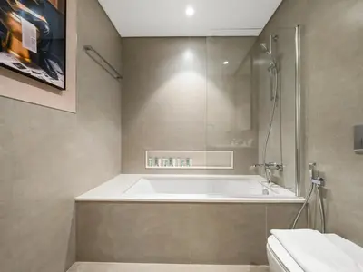 a bathroom with a tub and a shower and a toilet at 51st Floor Sea and Skyline Views LUXE 1BR in Dubai