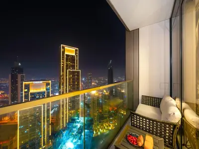 a balcony with a view of a city at night at 51st Floor Sea and Skyline Views LUXE 1BR in Dubai