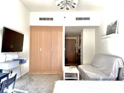 a living room with a bed and a tv in it at Luxury studio appartment in Sabkhah