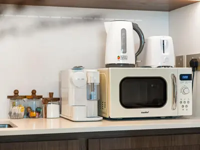 a microwave sitting on top of a kitchen counter at Chic 1 Bedroom with Palm Views in Palace Beach Residence in Dubai