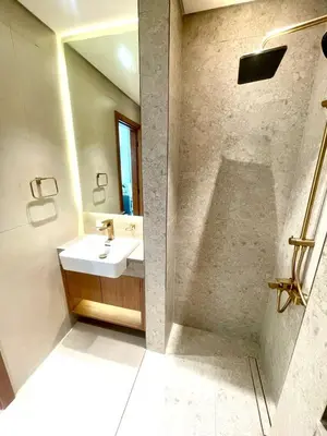 a bathroom with a sink and a mirror at Premium Stylish Studio in JVC in Dubai