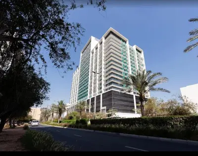 a tall building on the side of a street at Premium Stylish Studio in JVC in Dubai