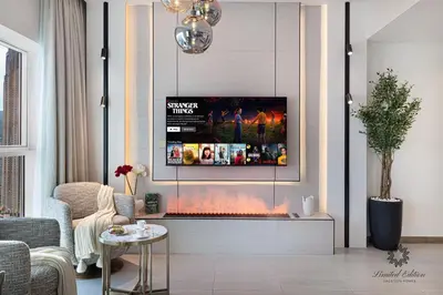 a living room with a fireplace with a tv above it at Luxury Apartments - Urban Oasis by Missoni - Business Bay - Canal View - 10 Minutes from Dubai Mall Burj Khalifa in Dubai