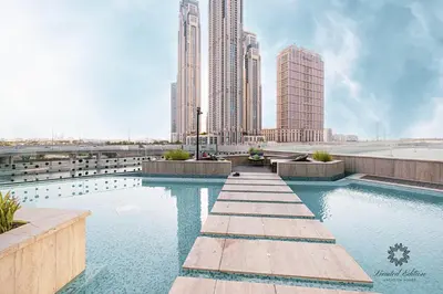 a swimming pool in a city with tall buildings at Luxury Apartments - Urban Oasis by Missoni - Business Bay - Canal View - 10 Minutes from Dubai Mall Burj Khalifa in Dubai