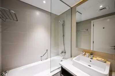 a bathroom with a tub and a sink and a shower at Canal View Studio near Dubai Mall in Dubai