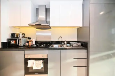 a kitchen with a sink and a stove at Canal View Studio near Dubai Mall in Dubai