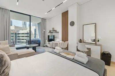 a bedroom with a bed and a living room at BLVD Retreat - Luxury Oasis with Private Jacuzzi and Iconic Burj Khalifa Views in Dubai