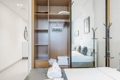a bedroom with a sliding door leading to a bed at BLVD Retreat - Luxury Oasis with Private Jacuzzi and Iconic Burj Khalifa Views in Dubai