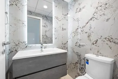 a bathroom with a sink and a toilet at Luxury 4BR w Marina Views Near Beach & Mall in Dubai