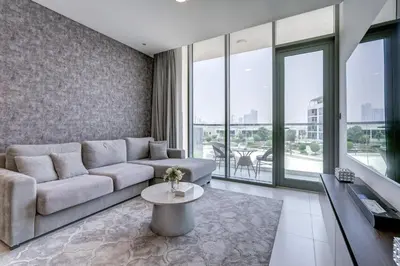 a living room with a couch and a table at PVH - Lagoon View 1BR - District One in Dubai