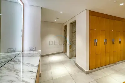 a dressing room with wooden lockers and a hallway at 3BR Overlooking Sea, Ain Dubai, and Bluewaters Island, Walking Distance to the Beach, The Address Residences, Jumeirah Beach Residence by Deluxe Holiday Homes in Dubai