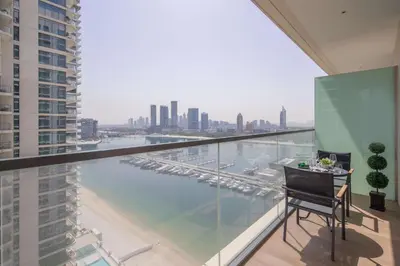 a balcony with a table and a view of the water at Frank Porter - Marina Vista in Dubai