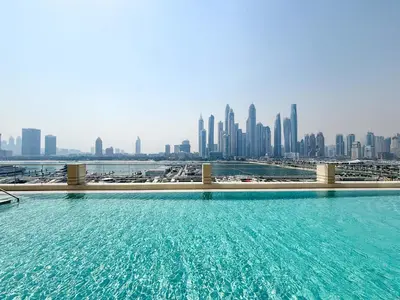 a swimming pool with a city skyline in the background at Frank Porter - Marina Vista in Dubai