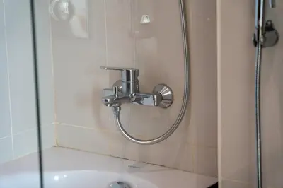 a shower with a faucet in a bathroom at Panoramic Burj Khalifa View - Damac Distinction Downtown Dubai in Dubai