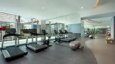 a gym with treadmills and exercise equipment in a building at Panoramic Burj Khalifa View - Damac Distinction Downtown Dubai in Dubai