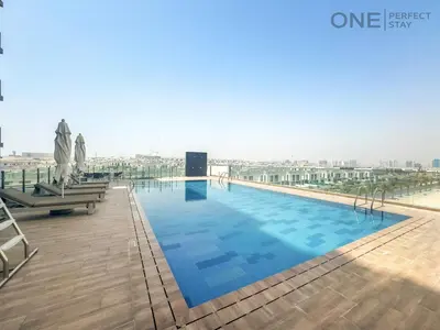 a large swimming pool on the roof of a building at Modern 1-Bedroom Apartment in Al Furjan With Pool & Gym in Dubai