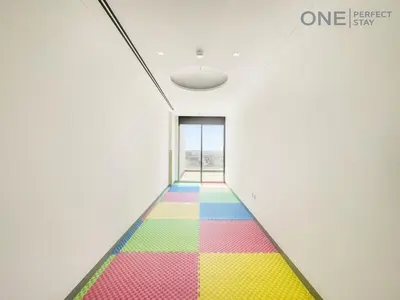 a rainbow carpet in a room with a window at Modern 1-Bedroom Apartment in Al Furjan With Pool & Gym in Dubai